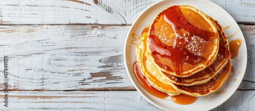 Close-up of delicious homemade caramel stuffed pancakes on a white wooden background with selective focus, top view, and spacious area for text or images - a great copy space image. photo