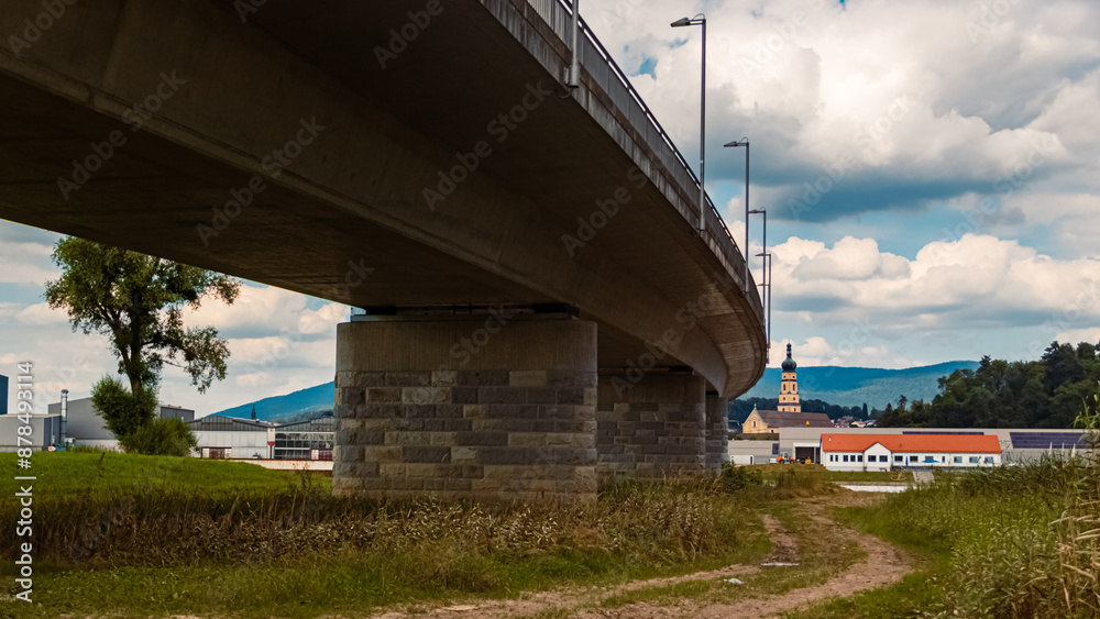 Cloudy summer view with a bridge and churches near Deggendorf, Danube, Bavaria, Germany Cloudy summer view with a bridge and churches near Deggendorf, Danube, Bavaria, Germany