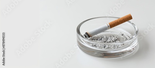 Close-up slightly blurred shot of a transparent ashtray or cigarette holder on a white background with copy space image.