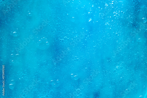 Air bubbles in the water background.Abstract oxygen bubbles in the sea.Water bubbles isolate on blue background.Sunlight underwater with bubbles rising to water surface in the sea