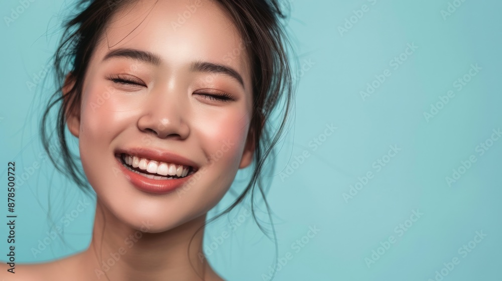 A close-up portrait of a smiling Asian woman A close-up portrait of a smiling Asian woman
