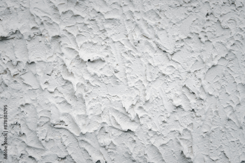 The wall is covered in white paint and has a rough texture. The wall appears to be unfinished and has a somewhat unfinished look to it The wall is covered in white paint and has a rough texture. The wall appears to be unfinished and has a somewhat unfinished look to it