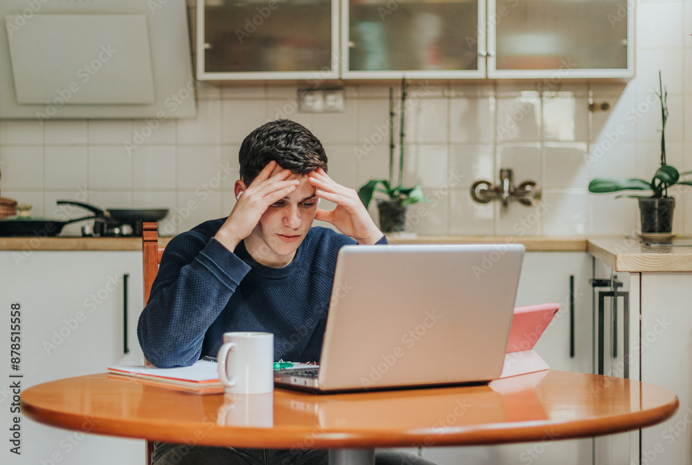 Young man stressed during a home study session Young man stressed during a home study session