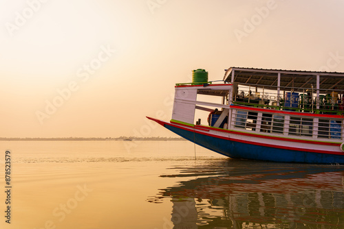Bild auf Leinwand A traditional tourist boat is seen sailing on a water channel at sunset