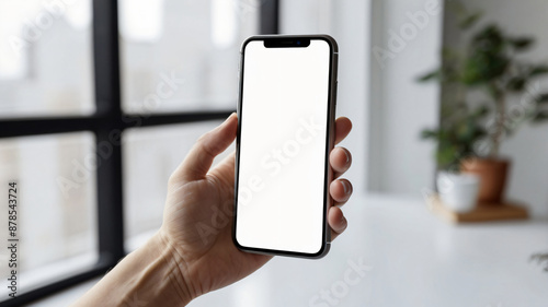 Person's hand holding black smartphone isolated on background, technology template