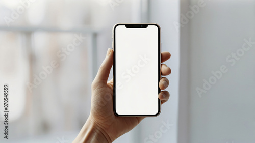 Person's hand holding black smartphone isolated on background, technology template