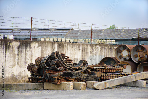 Industrial scrap metal that rusts is automotive industry parts and metal parts of large machines. Pile of various rusted industrial steel equipment on the floor in an factory 2025.