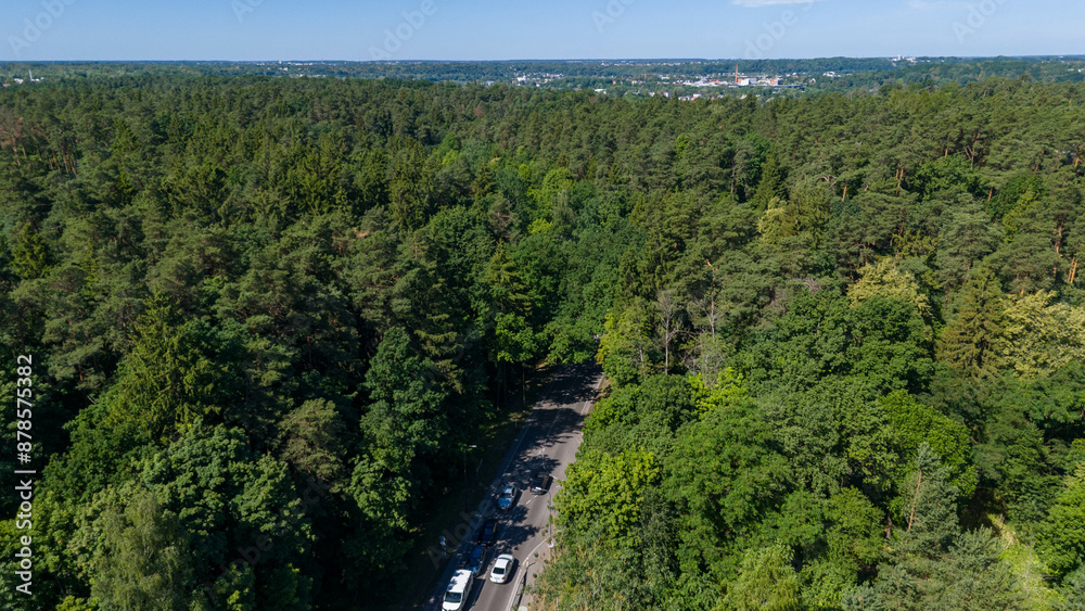 Drone photography of road, traffic, forest and houses during summer day Drone photography of road, traffic, forest and houses during summer day