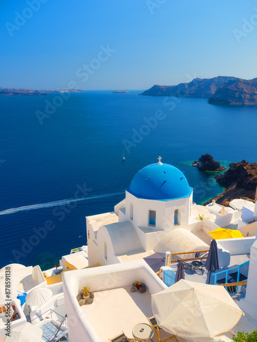 Santorini, Greece. Traditional houses in Santorini. Small narrow streets and rooftops of houses, churches and hotels. Oia village, Santorini Island, Greece. Travel and vacation photography.
