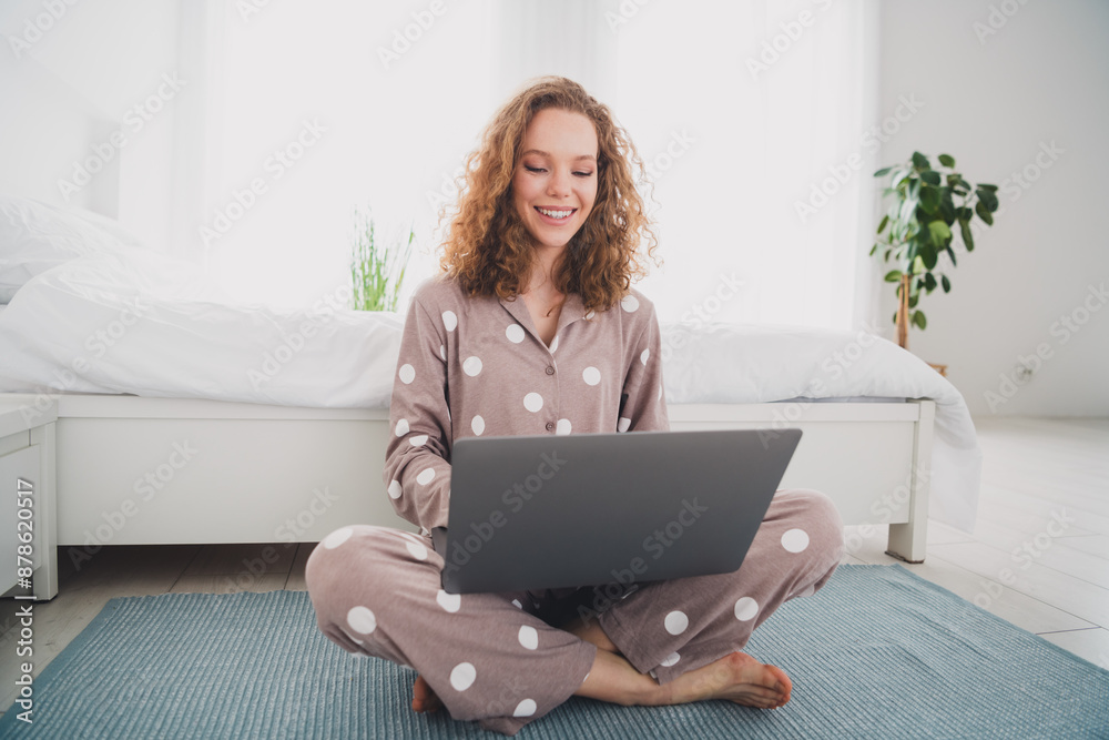 Full body portrait of nice young girl sit floor use laptop wear pajama bright interior bedroom flat indoors Full body portrait of nice young girl sit floor use laptop wear pajama bright interior bedroom flat indoors