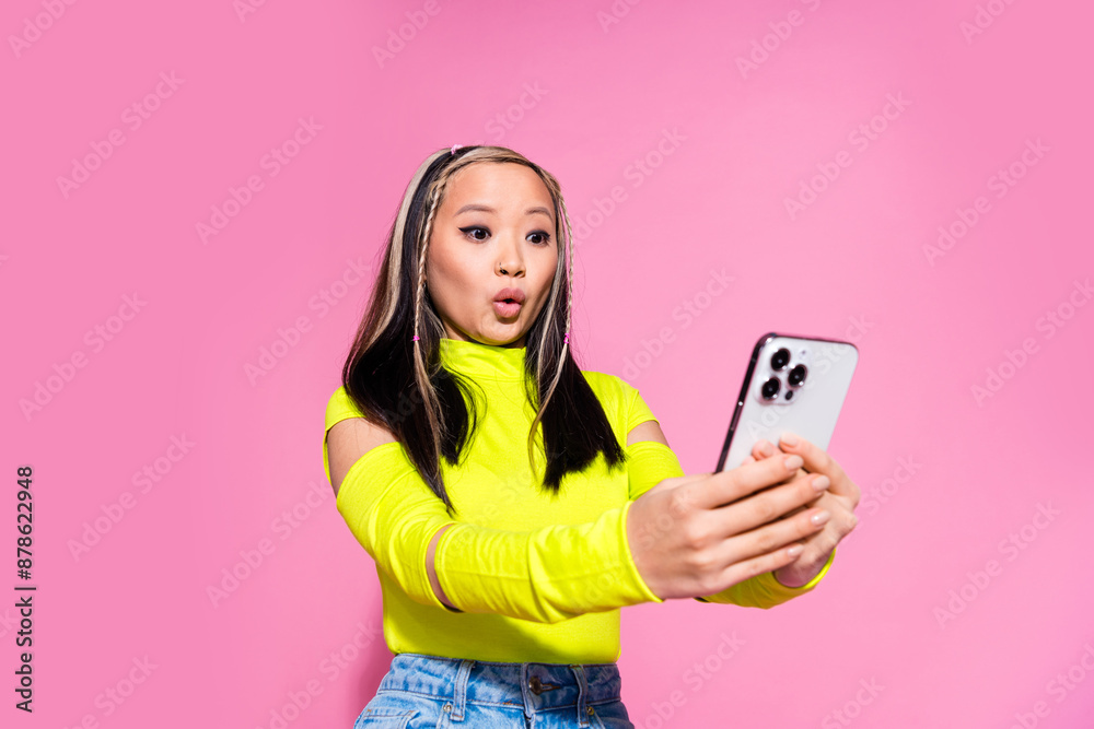 Photo of impressed lovely cute girl with dyed hairdo dressed yellow shirt read email on smartphone isolated on pink color background Photo of impressed lovely cute girl with dyed hairdo dressed yellow shirt read email on smartphone isolated on pink color background