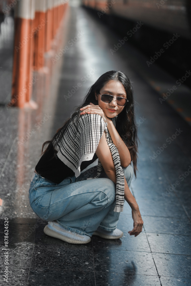Confident solo traveler, a stylish young woman waits at a bustling train station, embracing the adventure of exploring new destinations on her own Confident solo traveler, a stylish young woman waits at a bustling train station, embracing the adventure of exploring new destinations on her own