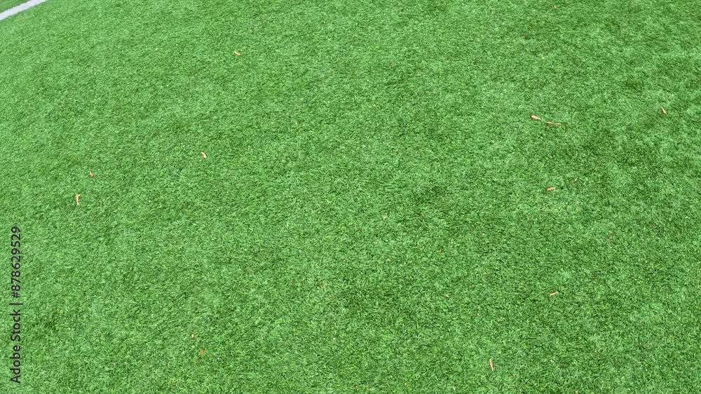 Football Field Turf in Motion. Slow motion wide angle views moving across a green turf football or soccer field with yard line markings. Overhead view. Football Field Turf in Motion. Slow motion wide angle views moving across a green turf football or soccer field with yard line markings. Overhead view.