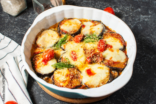 Italian dinner with homemade baked eggplant Parmigiana di melanzane, made with mozzarella, tomato.