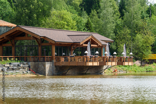 Cafe on the shore of the lake, wooden building with a veranda over the water.