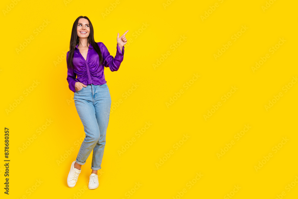 Photo of positive smiling lady promoter standing pointing empty space isolated bright color background Photo of positive smiling lady promoter standing pointing empty space isolated bright color background