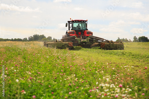 tractor, feed, harvesting, hay. A tractor mows the grass. haymaking, fodder harvesting. Copy space