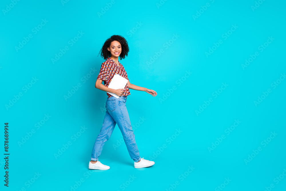 Full size photo of optimistic adorable woman dressed stylish blouse holding tablet go empty space isolated on blue color background