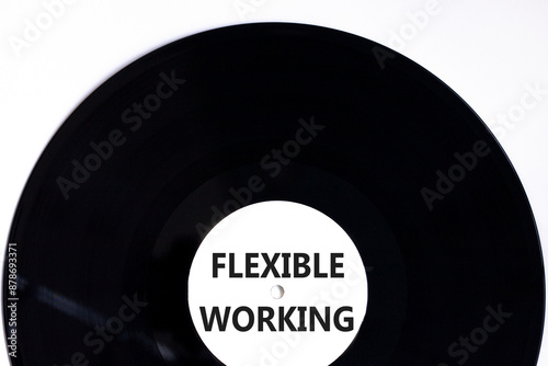 Flexible working symbol. Concept words Flexible working on beautiful white black vinyl disk. Beautiful white paper background. Business flexible working concept. Copy space.