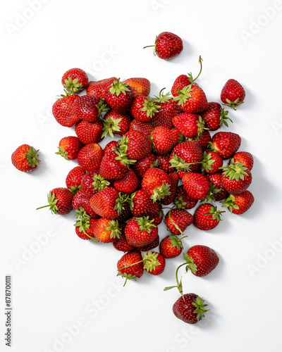 fresh strawberries scattered on a clean white background