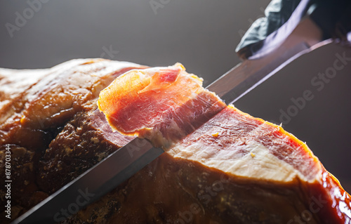 Chef cutting dry-cured spanish ham Jamon. photo