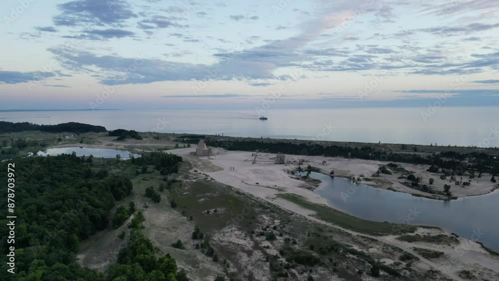 aerial view of sunset with large boat on coastline of lake aerial view of sunset with large boat on coastline of lake