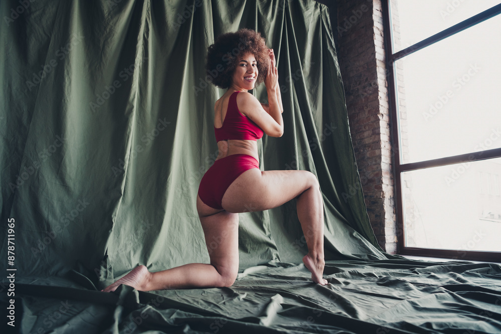 Unretouched photo of pretty girl plus size posing stand knee over green color background in studio Unretouched photo of pretty girl plus size posing stand knee over green color background in studio