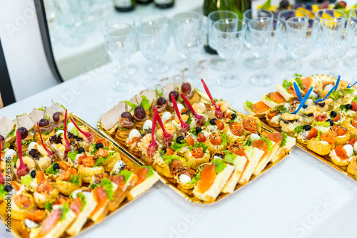 Fototapeta Naklejka Na Ścianę i Meble -  Gourmet Appetizers on Gold Trays at a Formal Event