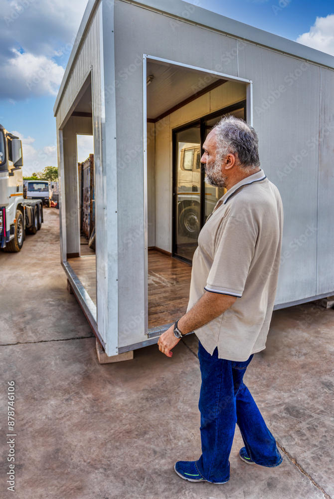 arab single old man with a beard and gray hair , walking in industrial yard, small business arab single old man with a beard and gray hair , walking in industrial yard, small business