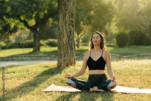 Female Practice Yoga Outdoors. young woman doing yoga position outdoors by a sea on a sunny day. morning meditation