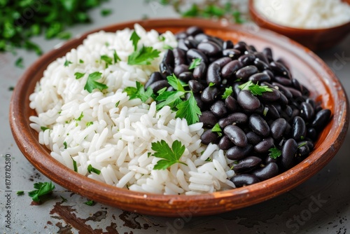 White rice and black beans with parsley decoration on plate. photo