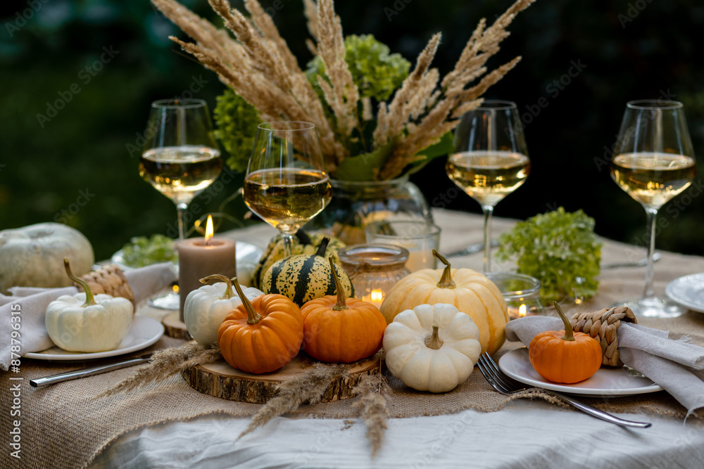 Autumn cozy mood table composition for family thanksgiving dinner with wine, pumpkins, candles on wooden tray. Fall mood, warm plaid. Hygge home decor, interior seasonal design Autumn cozy mood table composition for family thanksgiving dinner with wine, pumpkins, candles on wooden tray. Fall mood, warm plaid. Hygge home decor, interior seasonal design