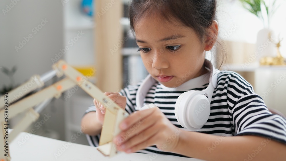 STEM education concept. Asian students learn at home with STEM toys, mathematics engineering science technology computer code in robotics for kids' concepts. STEM education concept. Asian students learn at home with STEM toys, mathematics engineering science technology computer code in robotics for kids' concepts.