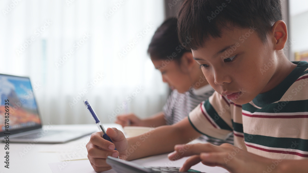 Asian elementary school children studying mathematics in class intently. Asian elementary school children studying mathematics in class intently.