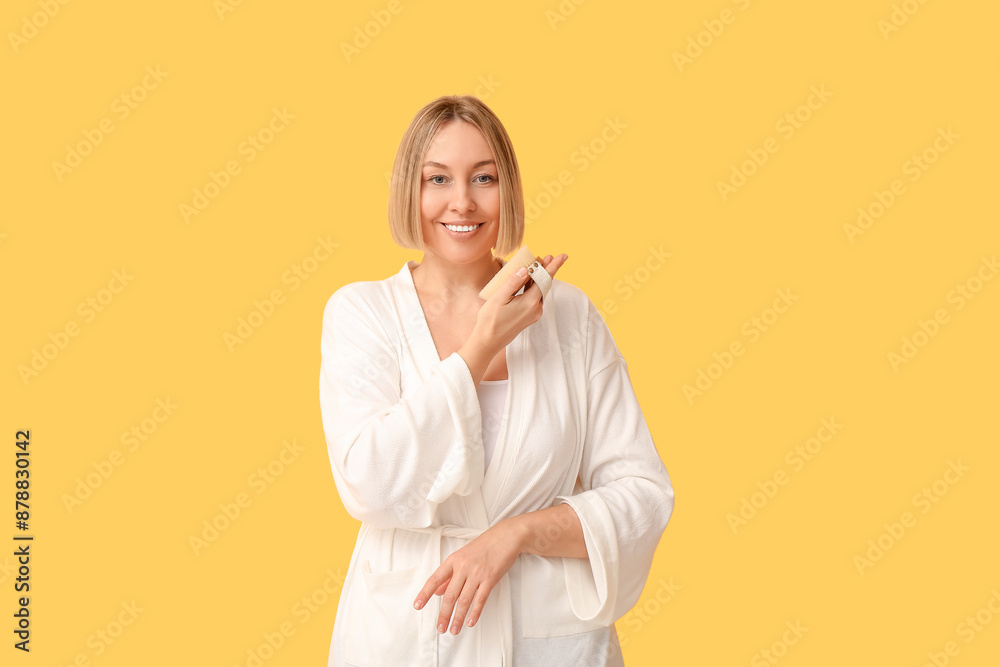 Beautiful young woman with body massage brush on yellow background Beautiful young woman with body massage brush on yellow background
