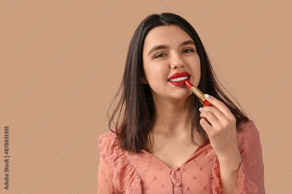 Happy young woman with red lips and lipstick on brown background Happy young woman with red lips and lipstick on brown background