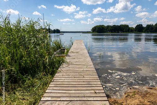 Pomost na plaży w słoneczny dzień Jezioro Lubie Zachodniopomorskie photo