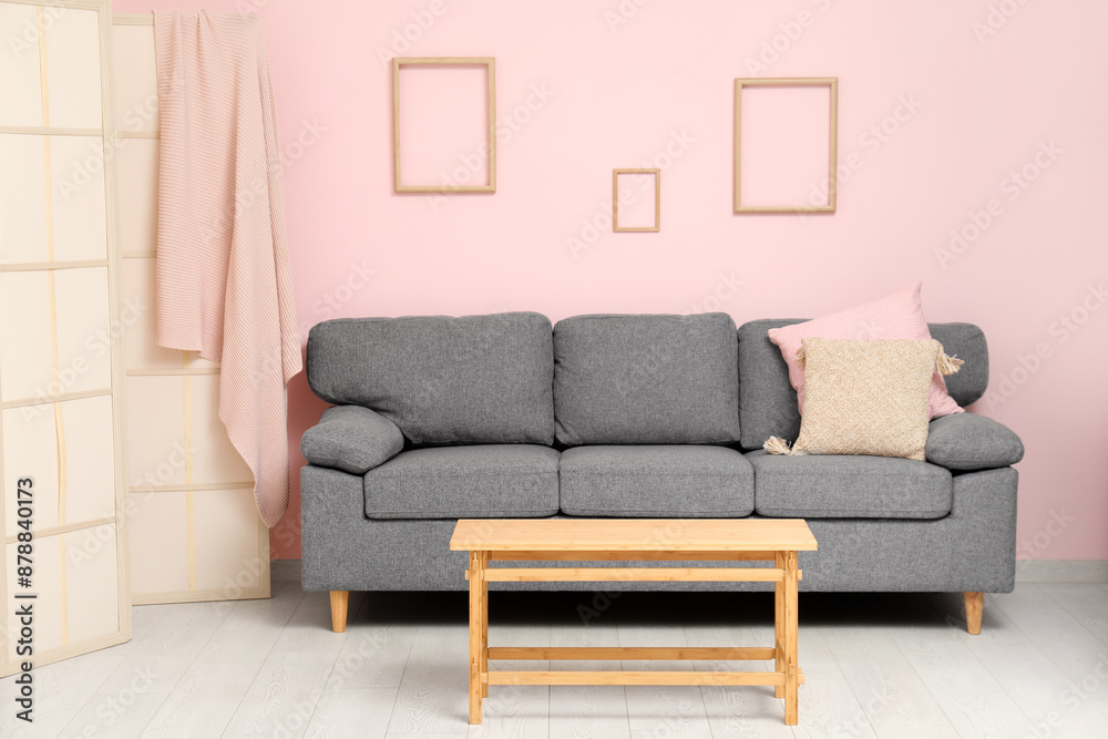Comfortable sofa with cushions and coffee table in interior of living room Comfortable sofa with cushions and coffee table in interior of living room