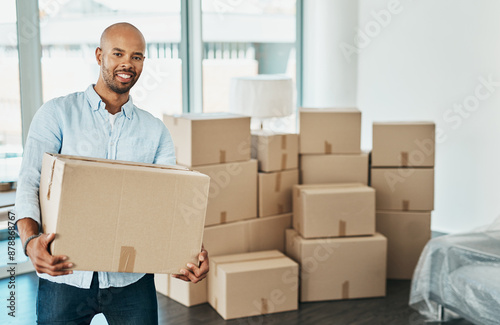 African man, boxes and smile in new house for portrait, package and excited for fresh start with property. Person, happy and moving to apartment, real estate and investment with mortgage in Chicago