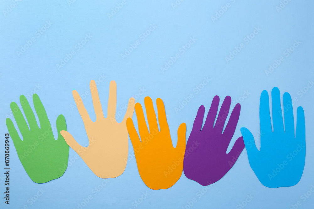 Obraz premium Equality concept. Different paper palms on light blue background, flat lay. Space for text