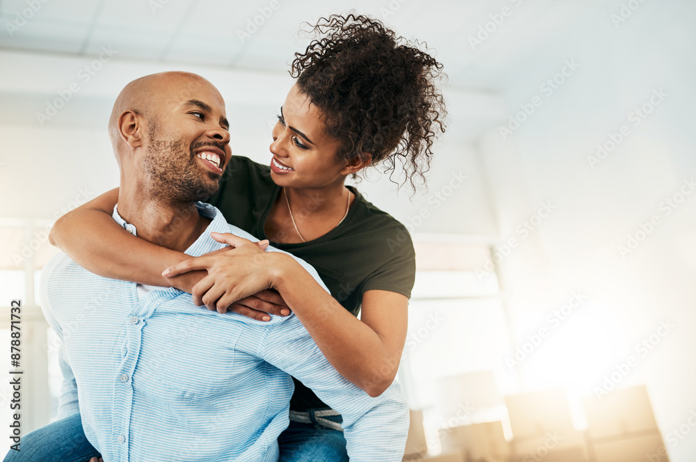 © SensSai/peopleimages.com - Man, woman and piggy back in new house with smile, hug and excited for fresh start with property. African couple, happy and moving with boxes in apartment, real estate and investment with mortgage