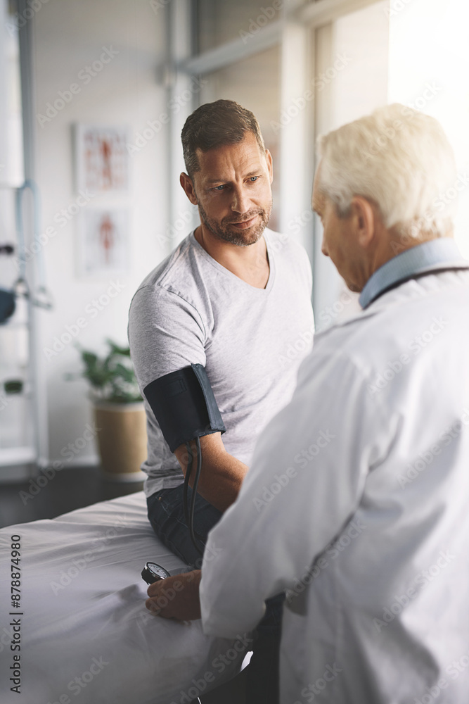 Healthcare, man and doctor in office for blood pressure, checkup and assessment in clinic. Advice, patient and medical professional in test for hypertension, cardiology or health consultation Healthcare, man and doctor in office for blood pressure, checkup and assessment in clinic. Advice, patient and medical professional in test for hypertension, cardiology or health consultation
