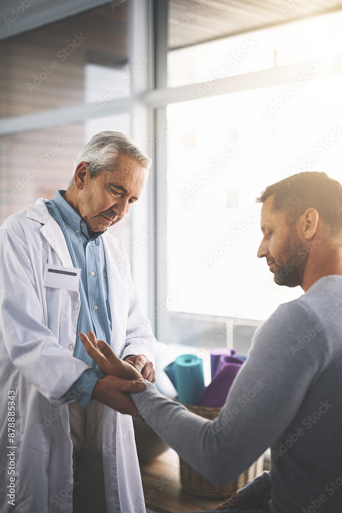 Obraz premium Healthcare, man and doctor checking wrist for physio, consultation and wellness assessment at clinic. Health insurance, patient and medical professional with hand for fitness evaluation for results