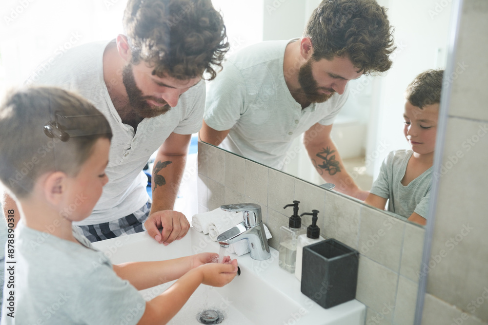 Bathroom, dad and kid washing hands with soap, learning and teaching for healthy hygiene in mirror. Cleaning, dirt and germs on fingers with boy, father and morning wellness for skincare in home. Bathroom, dad and kid washing hands with soap, learning and teaching for healthy hygiene in mirror. Cleaning, dirt and germs on fingers with boy, father and morning wellness for skincare in home.