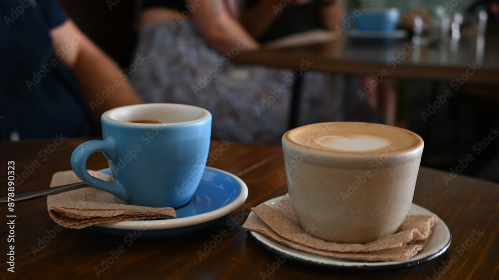 Two cups of coffee on a table - profile view Two cups of coffee on a table - profile view
