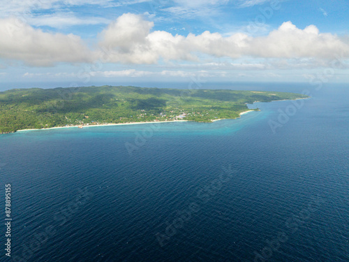 Tropical landscape of Island with beach surrounded by corals and blue sea. Carabao Island, Romblon. Philippines.