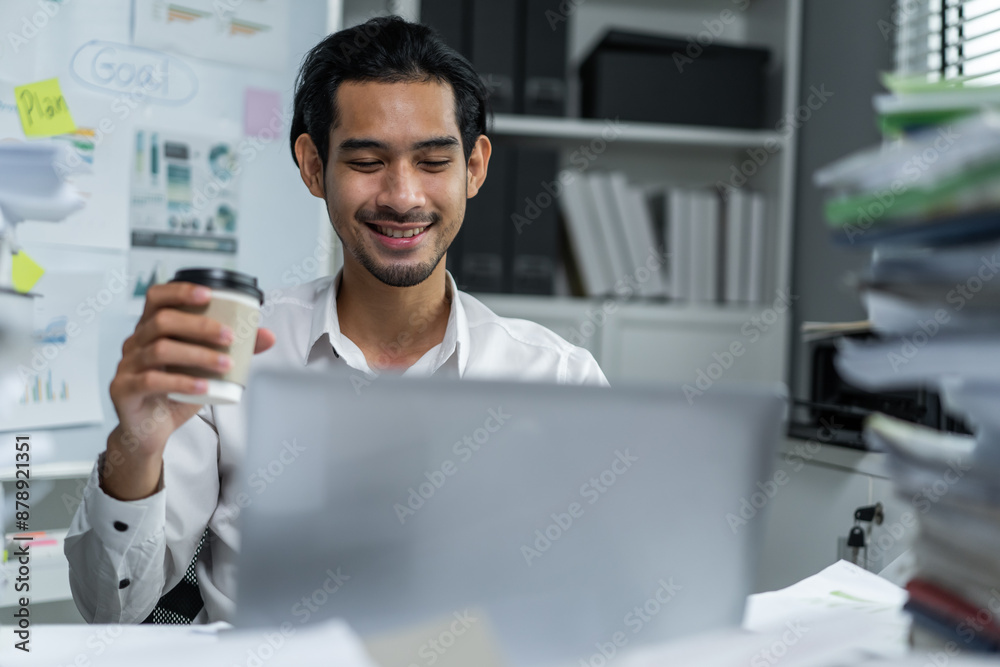 Asian handsome businessman using laptop computer working in the office. Asian handsome businessman using laptop computer working in the office.