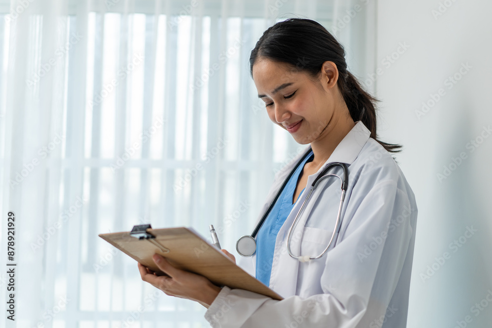 Asian female physician doctor wear gown standing in living room at home. Asian female physician doctor wear gown standing in living room at home.