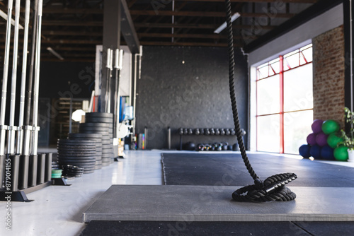 A well-equipped gym interior showcases fitness equipment, with copy space photo