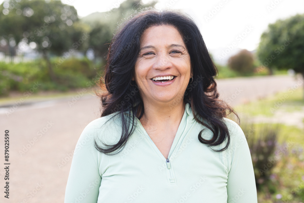 Portrait of happy senior biracial woman with long black hair smiling outdoors Portrait of happy senior biracial woman with long black hair smiling outdoors